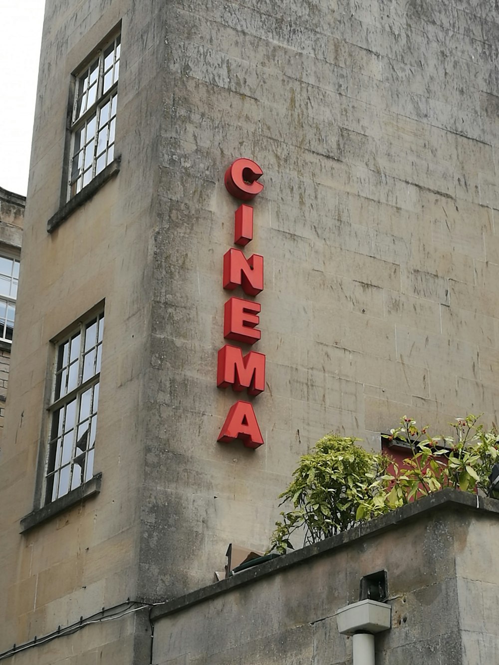 grey concrete Cinema building during daytime