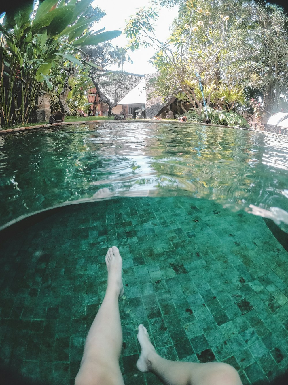 a person laying down in a swimming pool