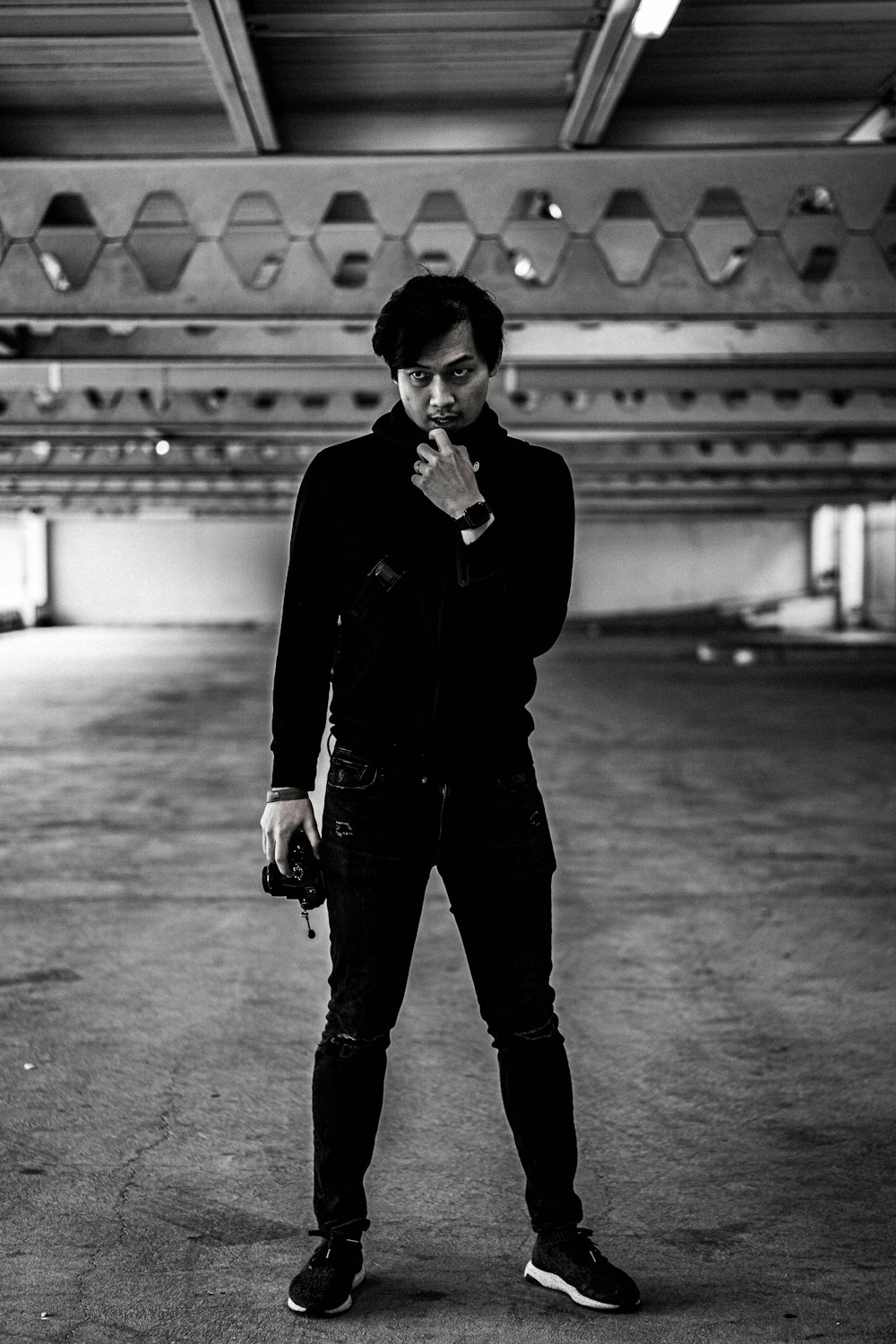 a man standing in an empty parking garage