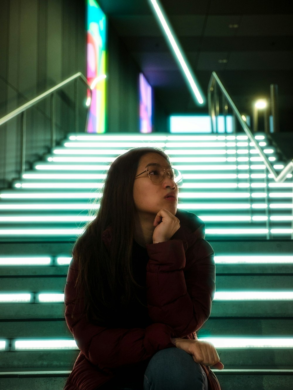 woman sitting on stairs looking upwards