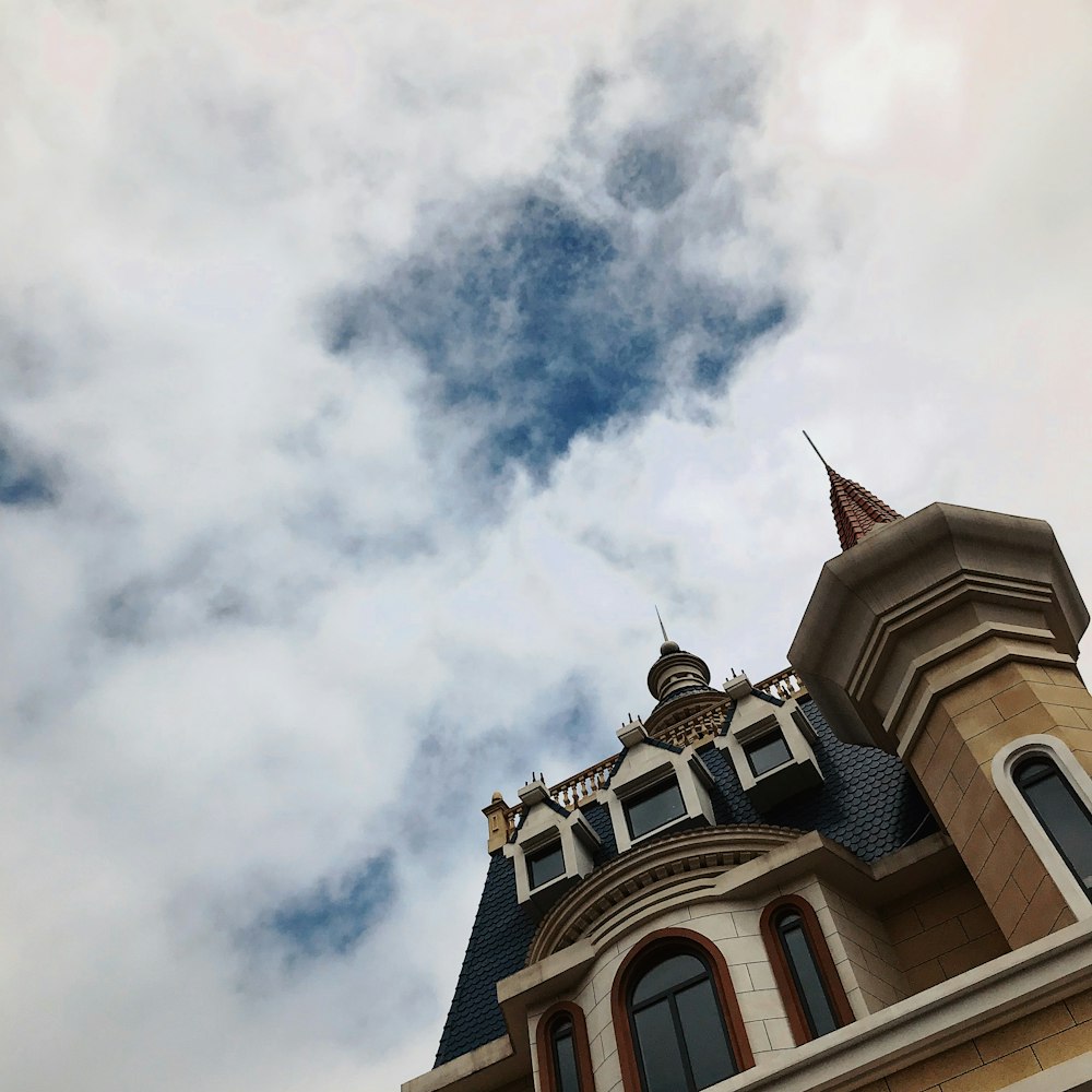 low-angle photo of mansion under heavy clouds