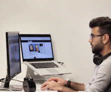 man wearing headphones using computer