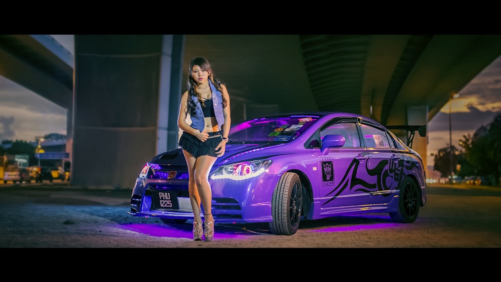 woman in front of purple sport car