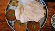 roti in round gray stainless steel tray
