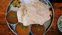 roti in round gray stainless steel tray
