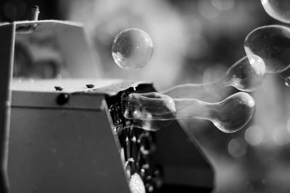 grayscale photo of bubble machine