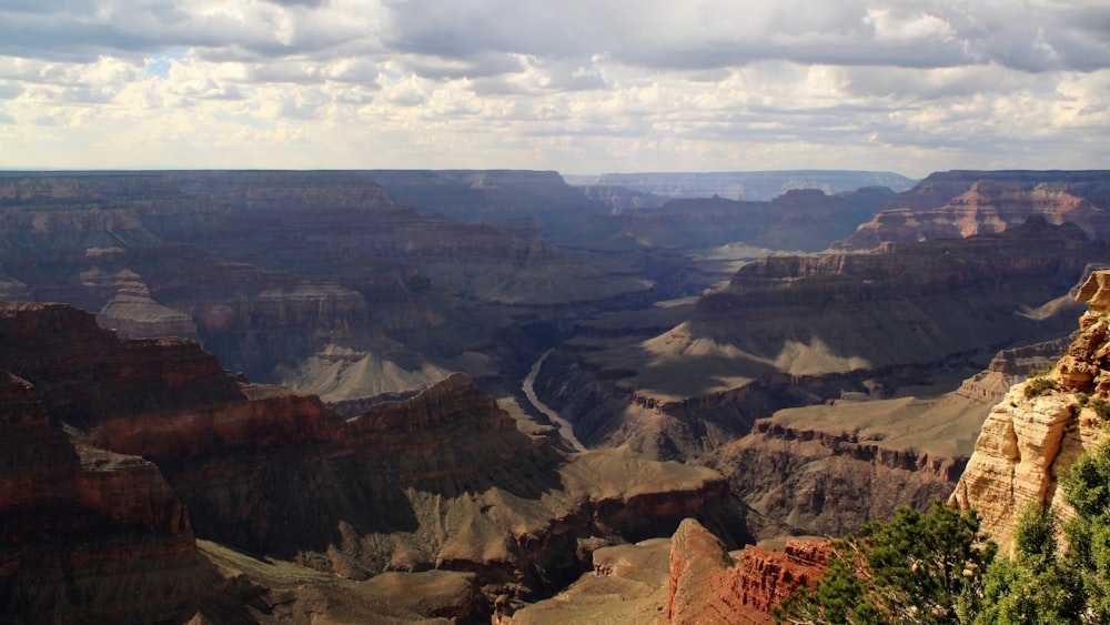 brown canyon under white clouds