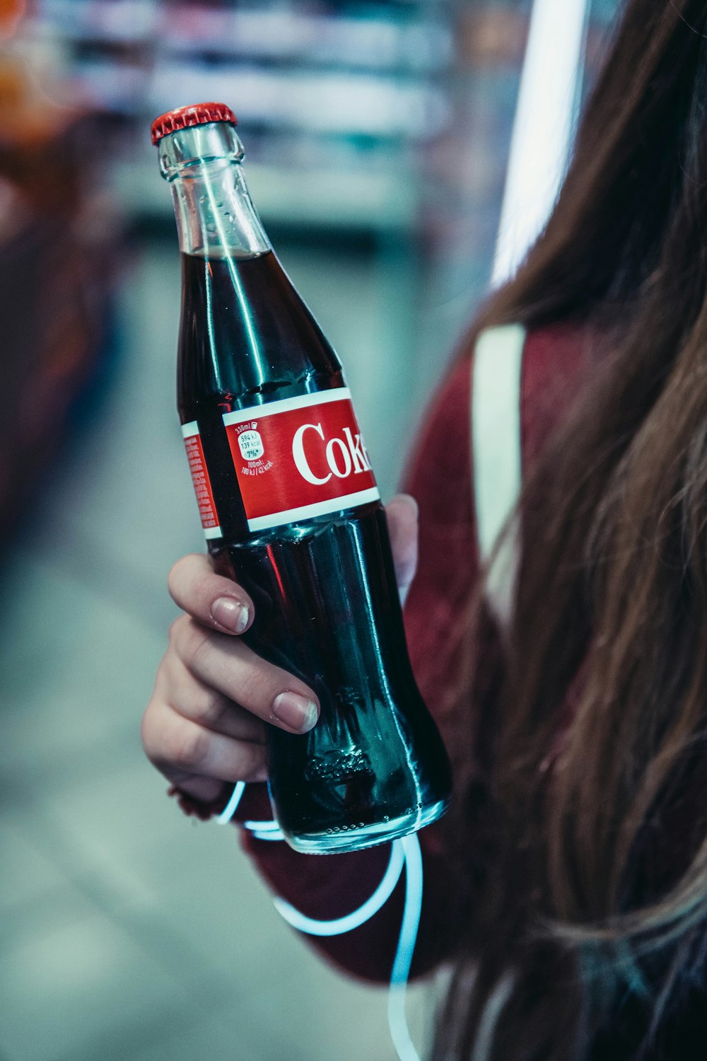 woman holding coke bottle