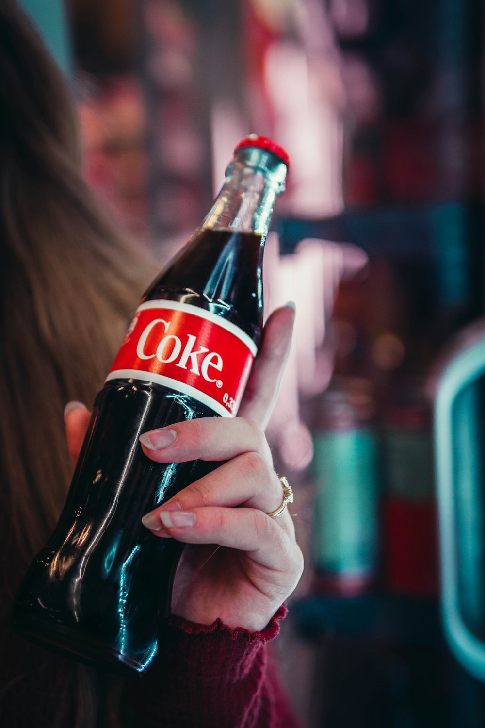 woman holding Coke bottle