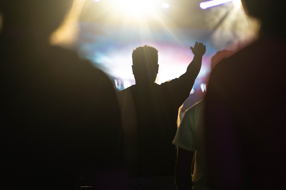 man raising his arm