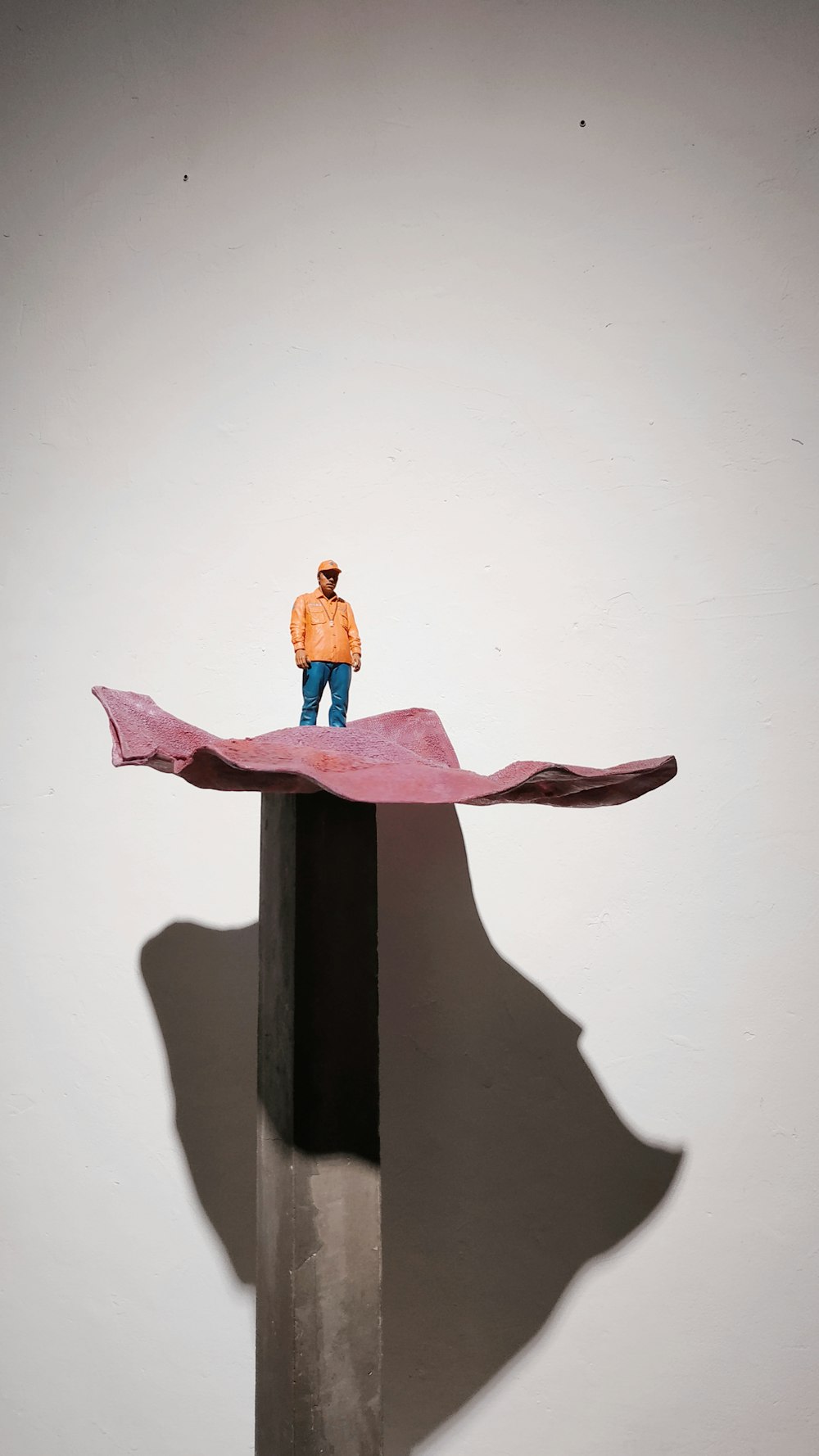 man standing on tower figurine