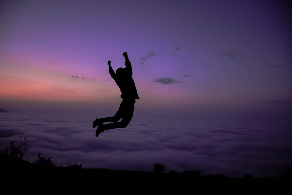 silhouette of jumping in mid air during golden hour