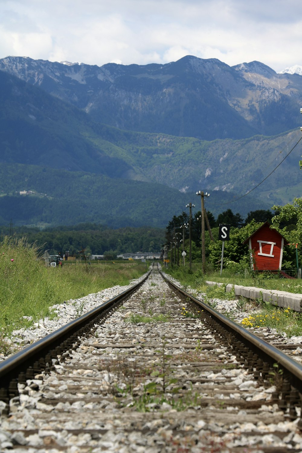 red shed beside train rails