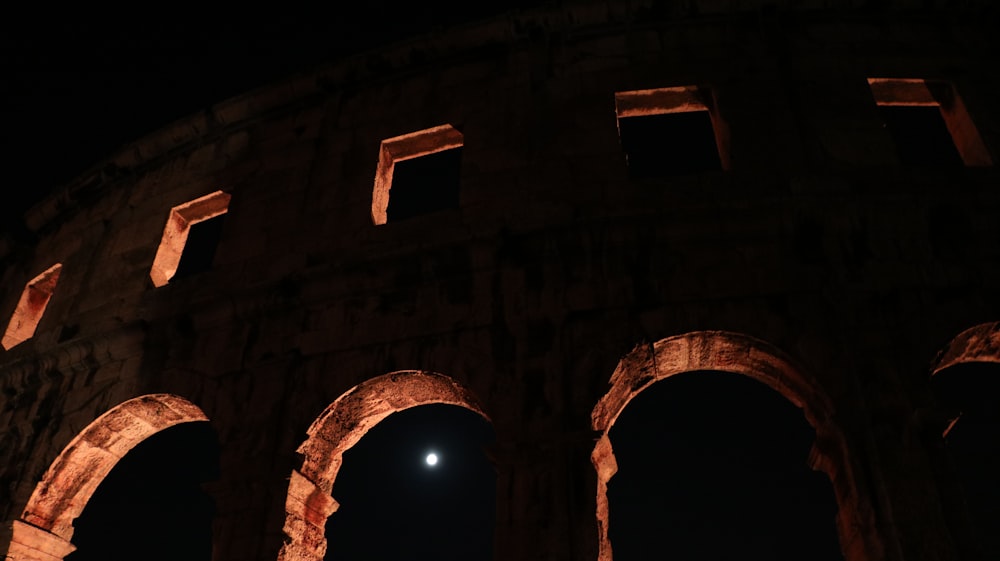 a full view of an ancient building at night