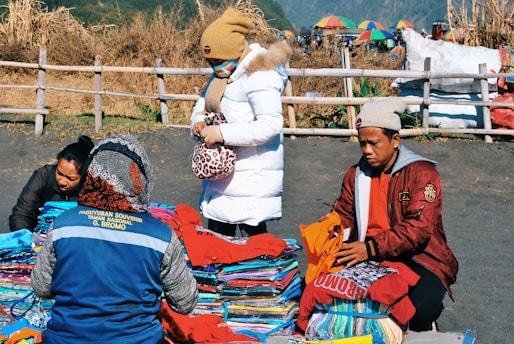 people sitting near apparel lot