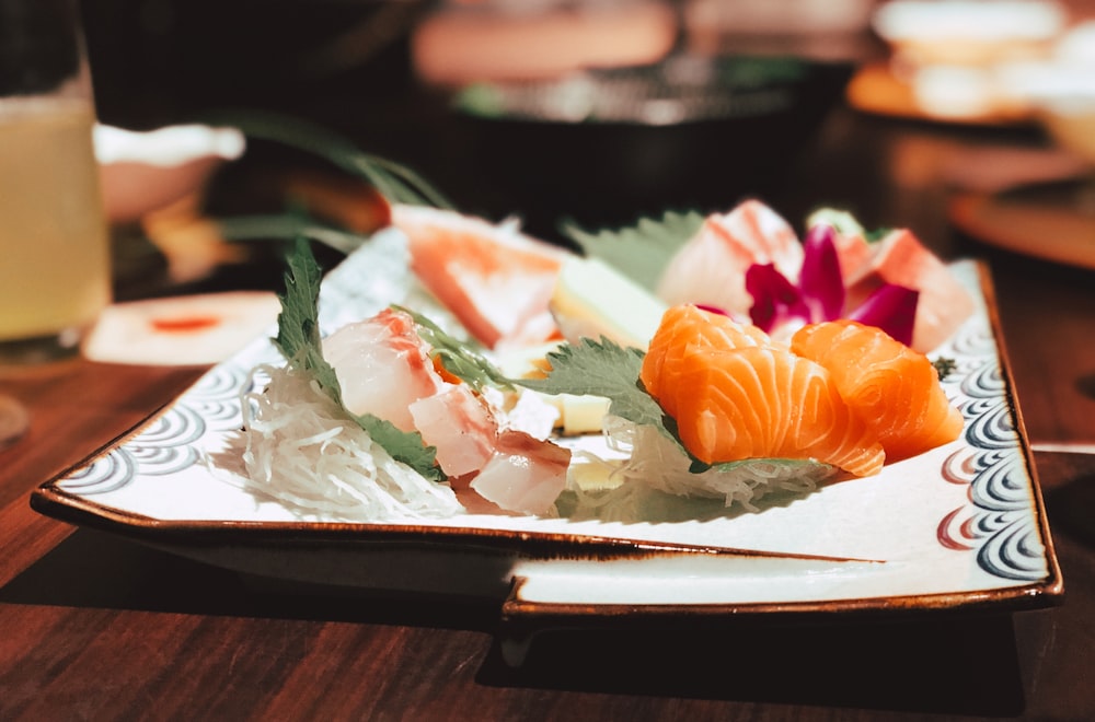 plate of sushi on wooden table