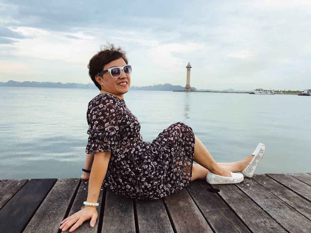 woman sitting on dock