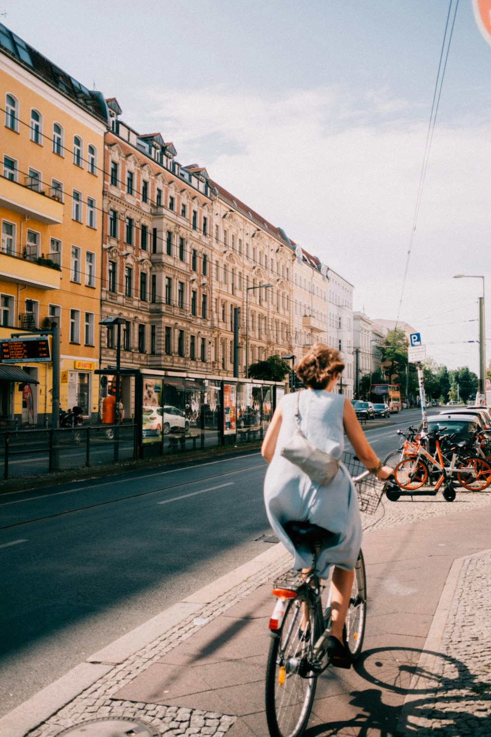 woman riding bicycle near concrete building