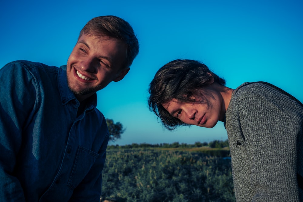 smiling man standing beside man