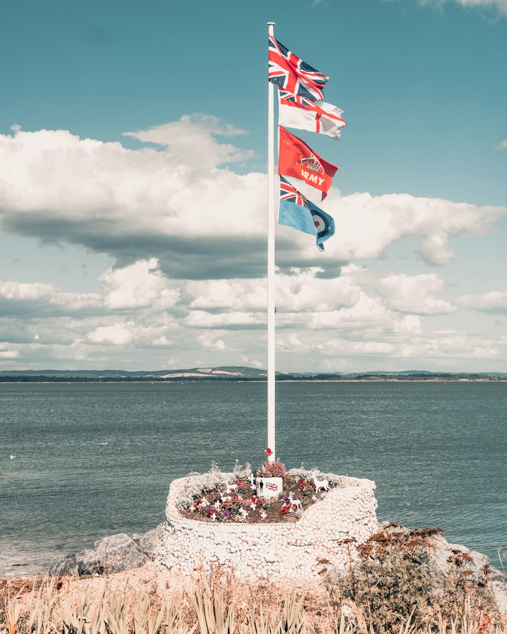 assorted British flags on a white pole