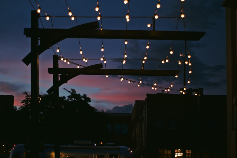 a city street at night with lights strung over it