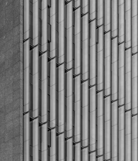 Close-up of vertical printed monocapa with stone pattern on a building facade.