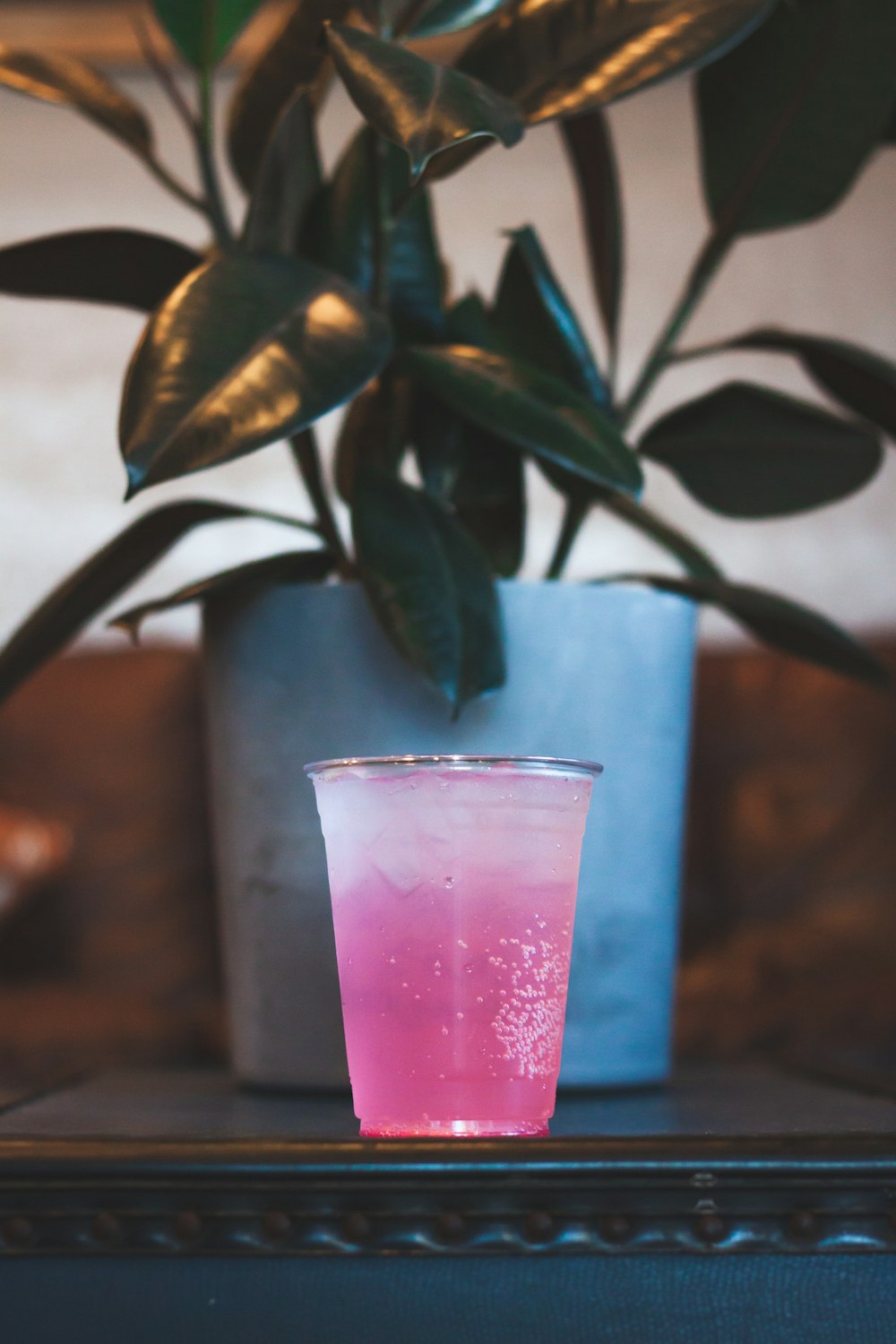 clear glass cup with pink liquid