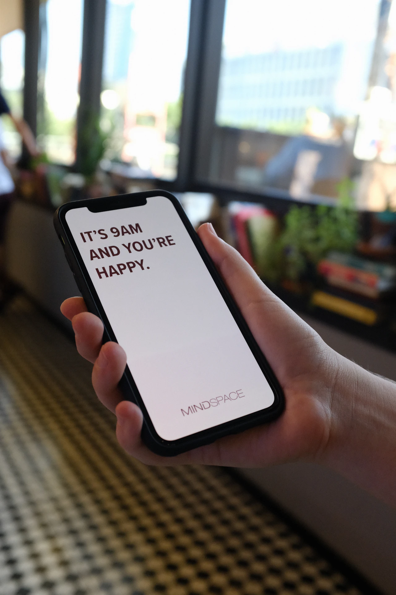 Someone checking a phone, where point balances and expiring reward reminders reach members between visits