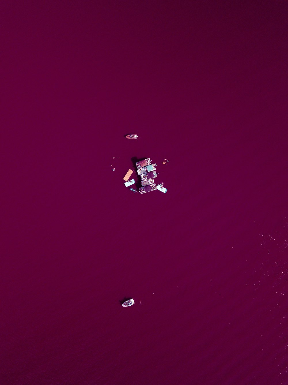 a small boat floating on top of a large body of water