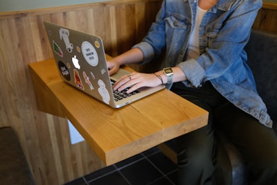 woman sitting and using MacBook