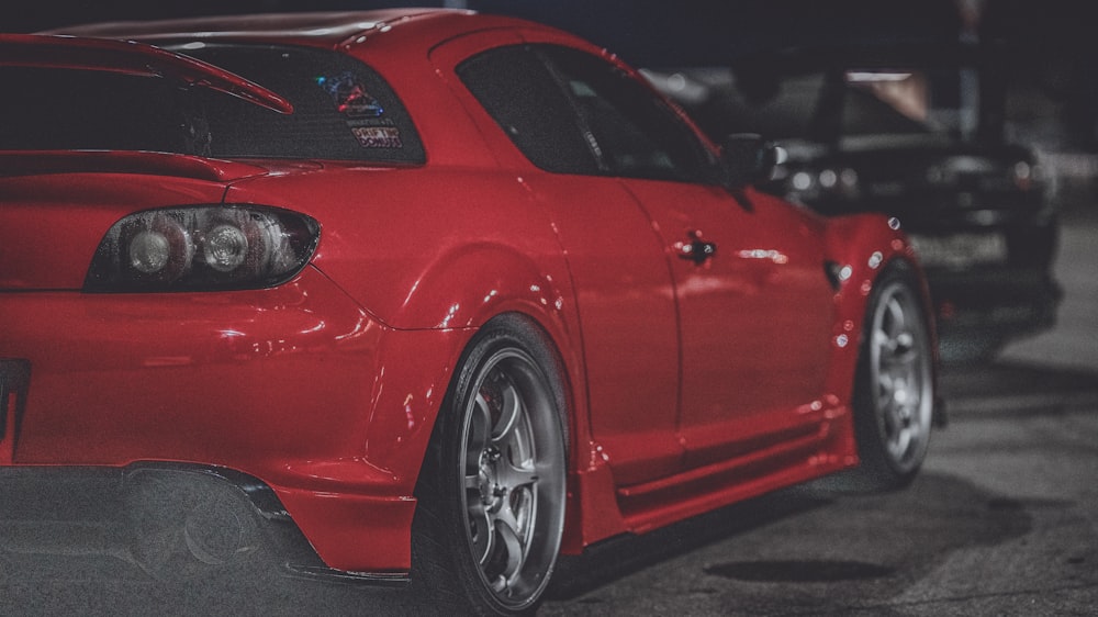 a red sports car parked in a parking lot