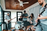 A vibrant group of musicians jamming together in a cozy studio space.