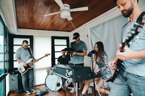A group of musicians jamming together in a cozy studio setting