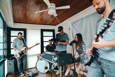 A vibrant group of musicians jamming together in a cozy studio space.