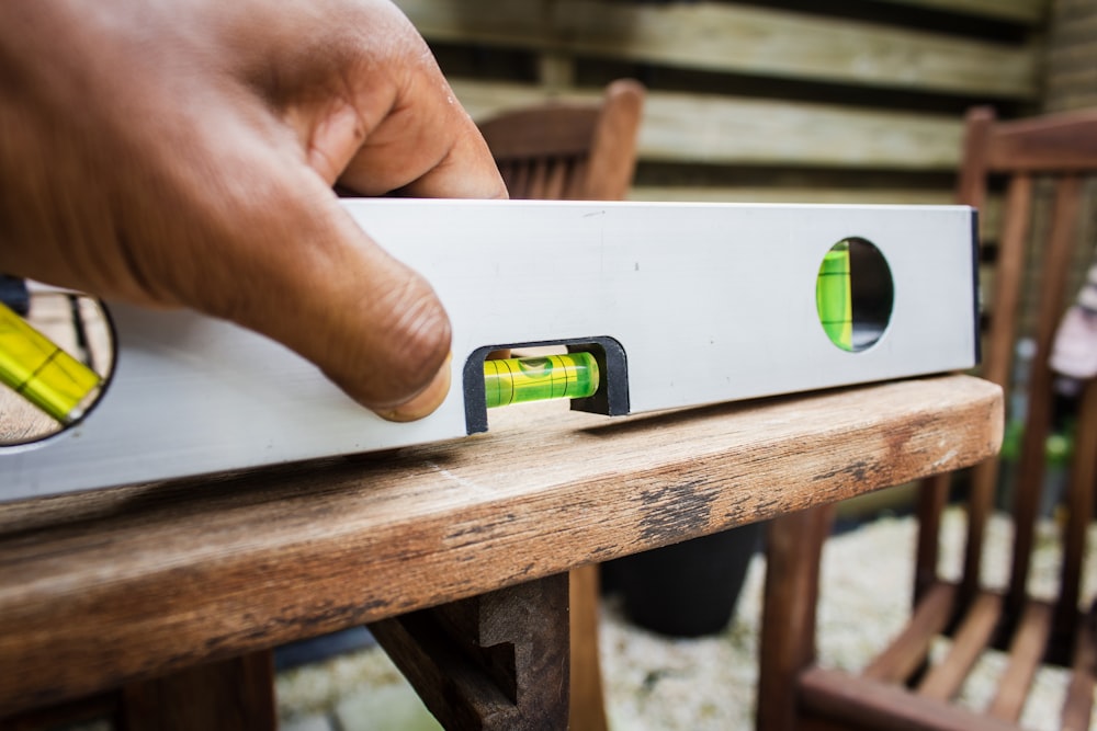 white spirit level on brown table