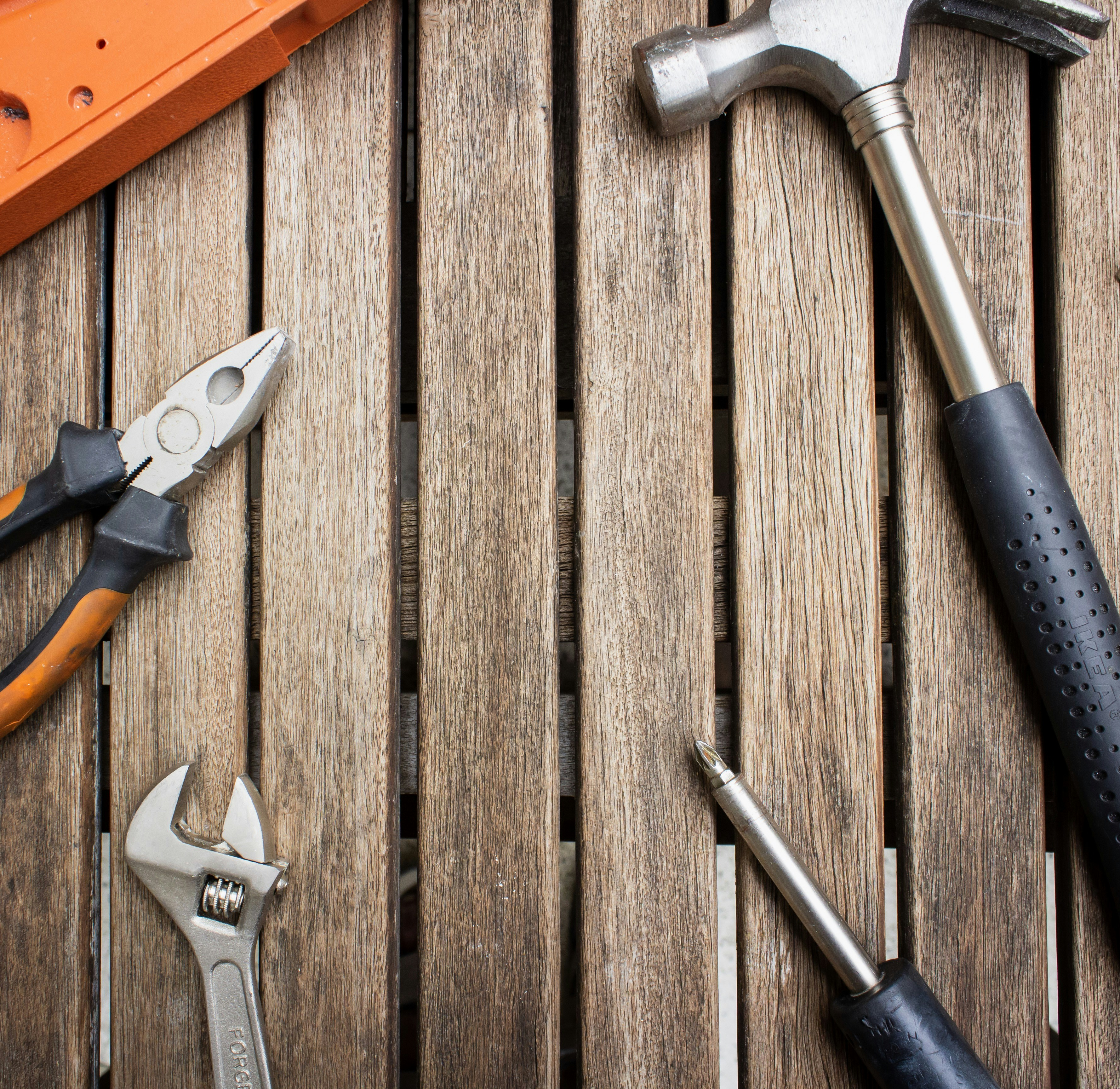 a variety of tools sitting on top of a wooden table