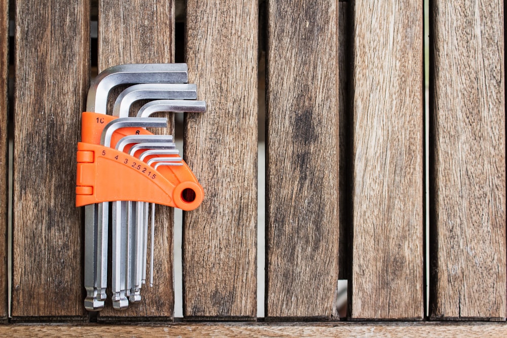 a bunch of keys hanging on a wooden wall