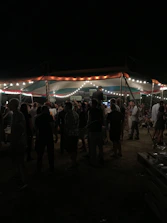 A joyful group of volunteers setting up a community event under soft teal lighting.