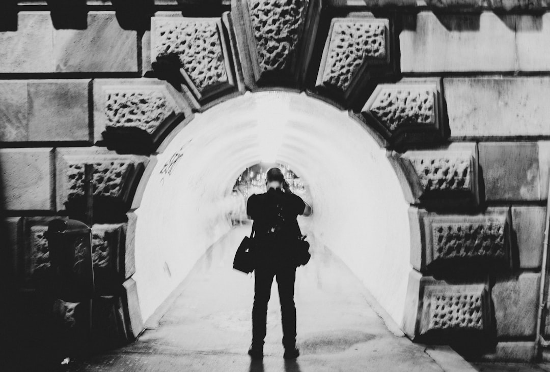 man standing between tunnel