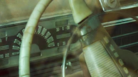 Image of a vintage car dashboard featuring a classic identification plate.