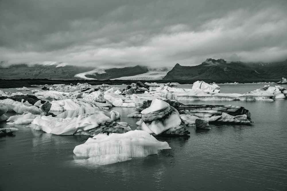 grayscale photography of body of water and mountain