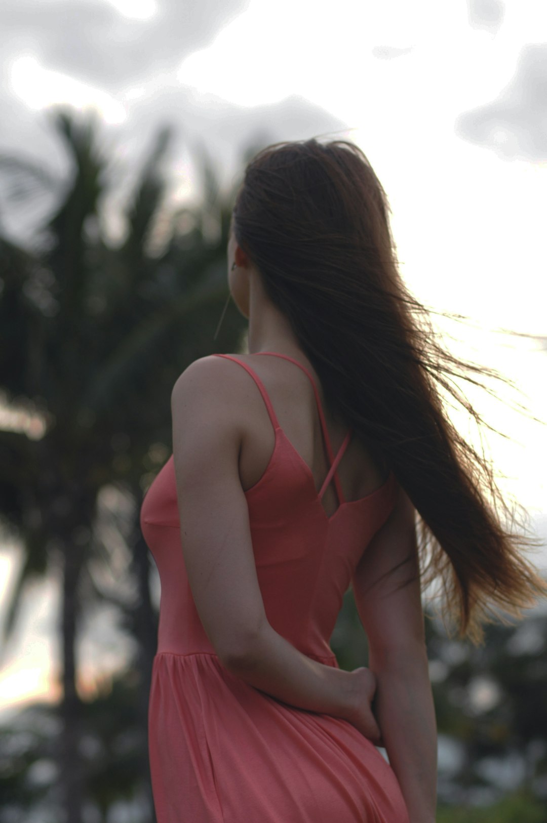 selective-focus photograph of woman in pink sleeveless dress