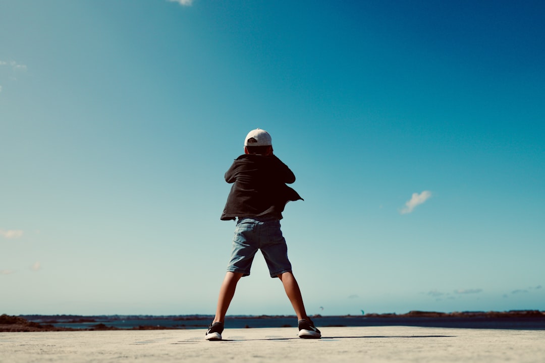 standing boy wearing black jacket