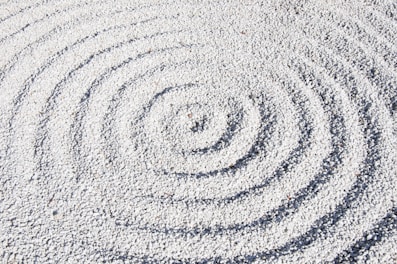 a circular design made of sand on a beach