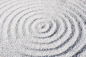 a circular design made of sand on a beach