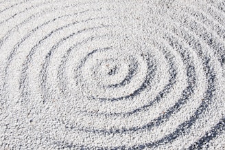 a circular design made of sand on a beach