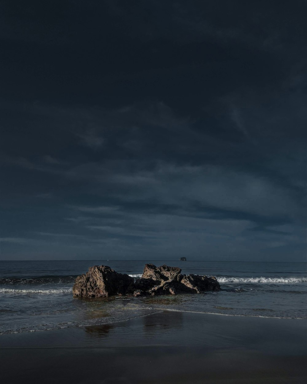 rocks beside ocean during daytime