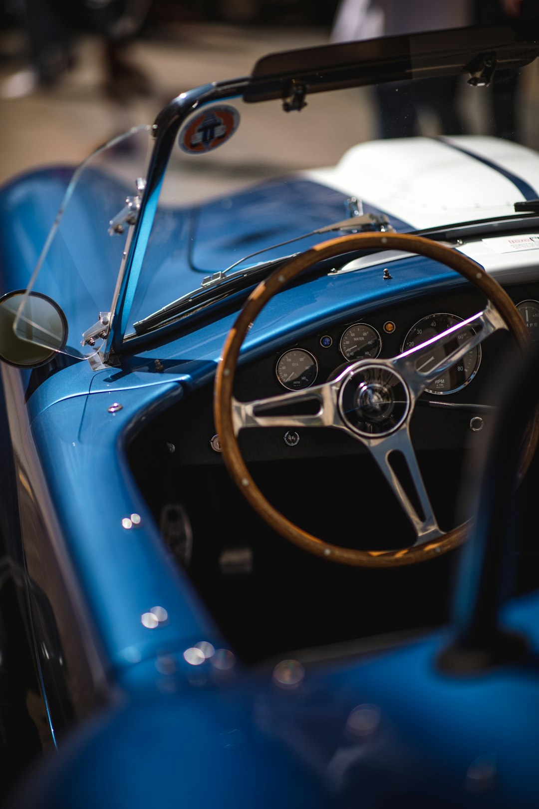 blue convertible car with brown and gray steering wheel
