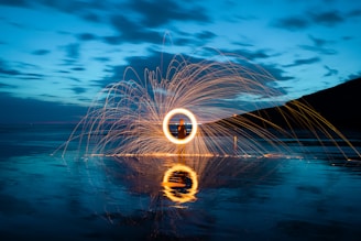 person in front of fire ring during nighttime