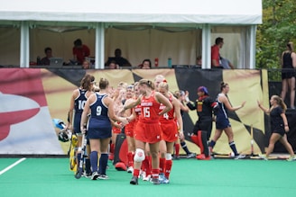 Group of players smiling and shaking hands after a spirited tournament game.